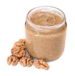 Photo of Tasty nut paste in jar and walnuts isolated on white