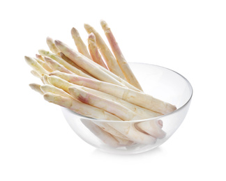 Photo of Fresh raw asparagus in glass bowl isolated on white