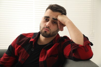 Photo of Portrait of sad lonely man at home