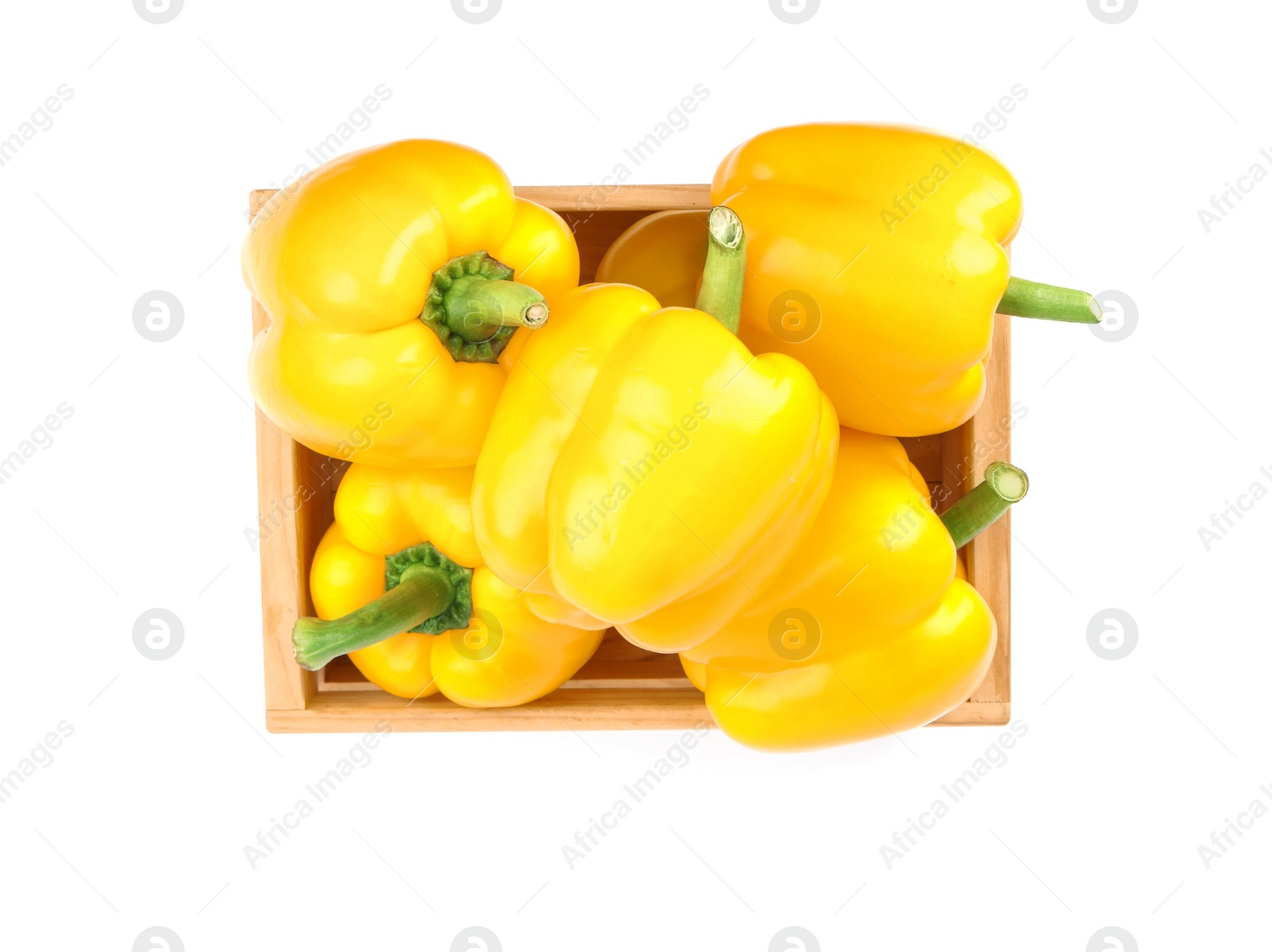 Photo of Crate of ripe yellow bell peppers isolated on white, top view