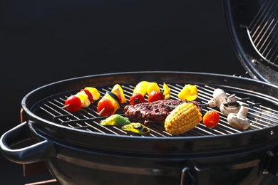 Photo of Tasty steak and vegetables on modern barbecue grill