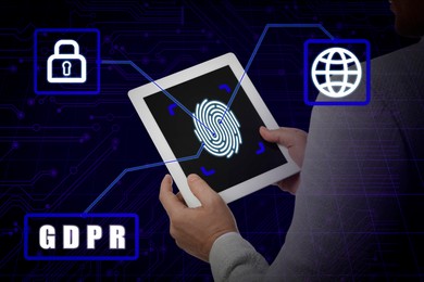 General Data Protection Regulation. Man holding tablet with fingerprint on screen against dark blue background with circuit board pattern, closeup. GDPR abbreviation, icons of padlock and globe linked to device