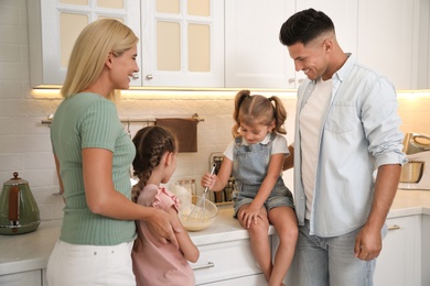 Photo of Happy family cooking together in modern kitchen