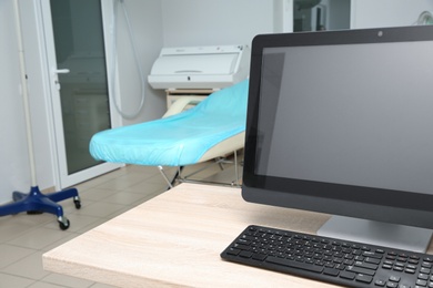 Doctor's workplace with computer in modern clinic, space for text