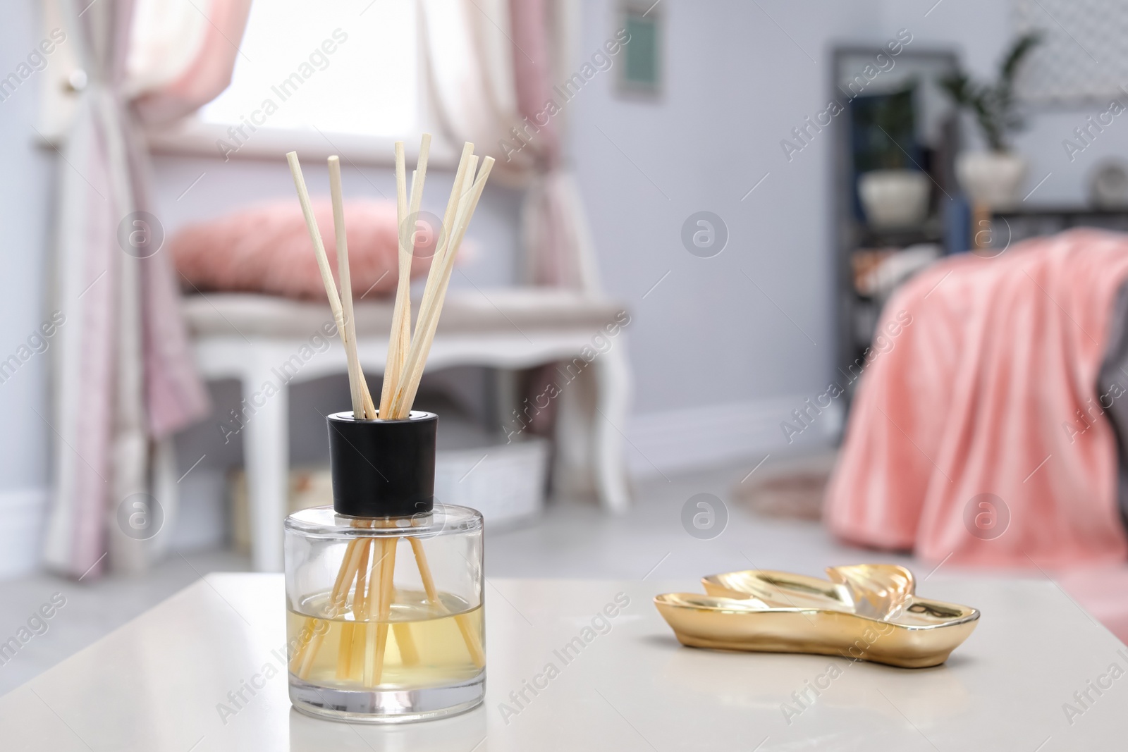 Photo of Reed freshener on table in bedroom