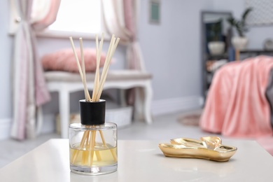 Reed freshener on table in bedroom