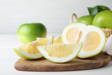 Photo of Cut fresh juicy sweetie on white table