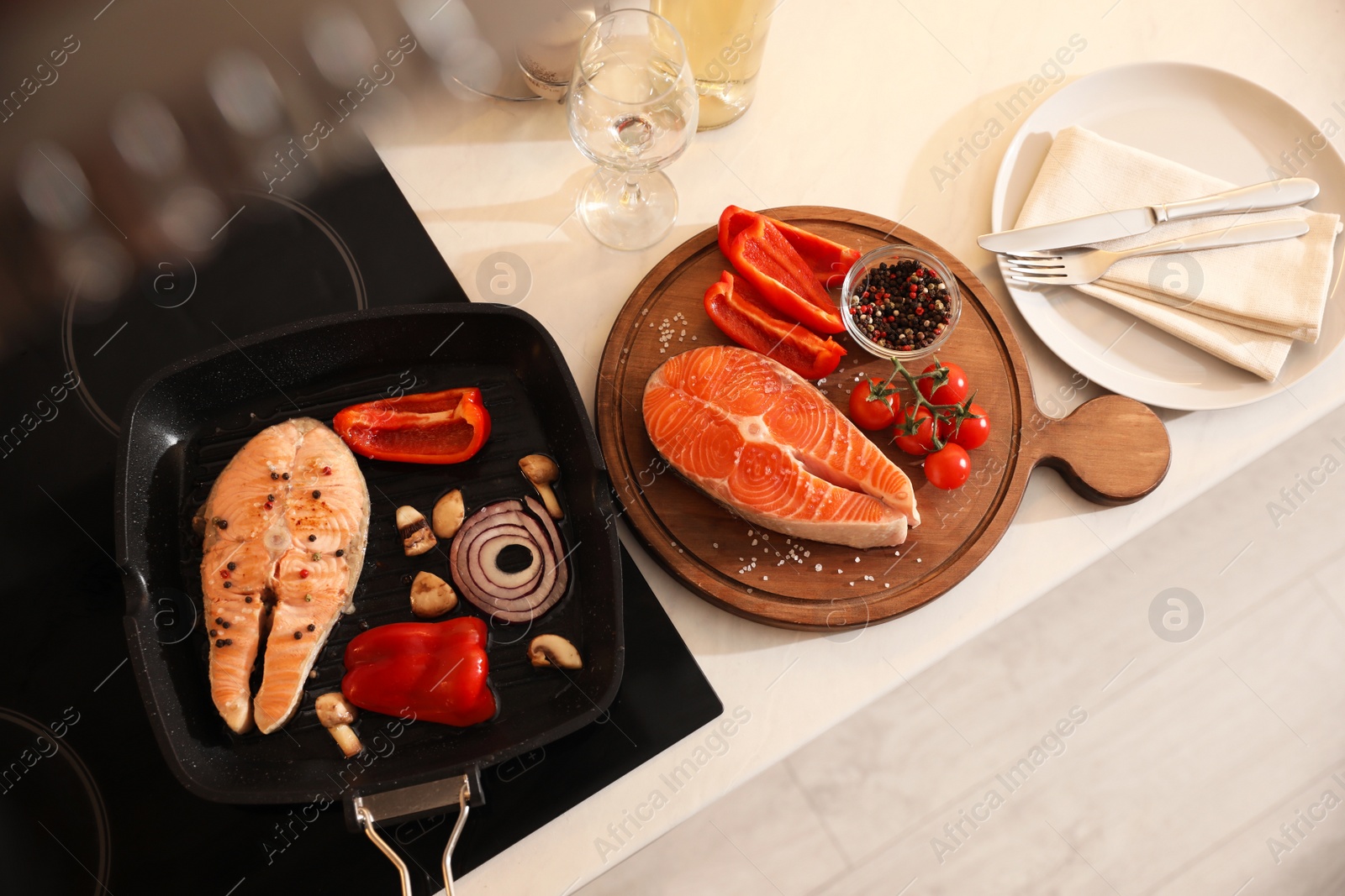 Photo of Composition with salmon steaks and vegetables in frying pan, above view