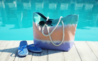 Photo of Beach accessories near swimming pool outdoors on sunny day