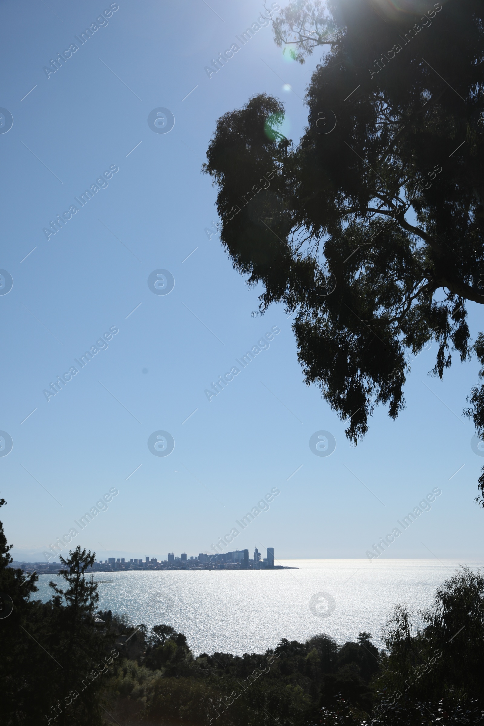 Photo of Picturesque view of beautiful sea and distant city under blue sky