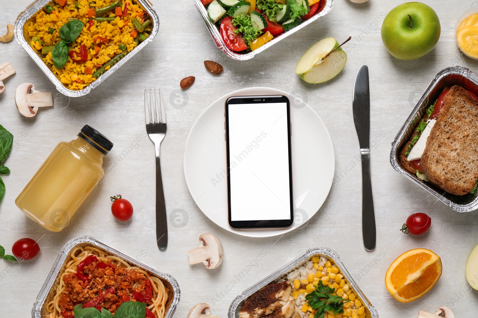 Photo of Flat lay composition with lunchboxes and smartphone on white wooden table, mockup for design. Healthy food delivery