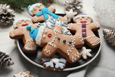 Photo of Delicious Christmas cookies and pine cones on table, closeup