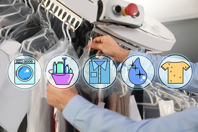 Image of Different icons and male worker taking clothes from garment conveyor at dry-cleaner's, closeup