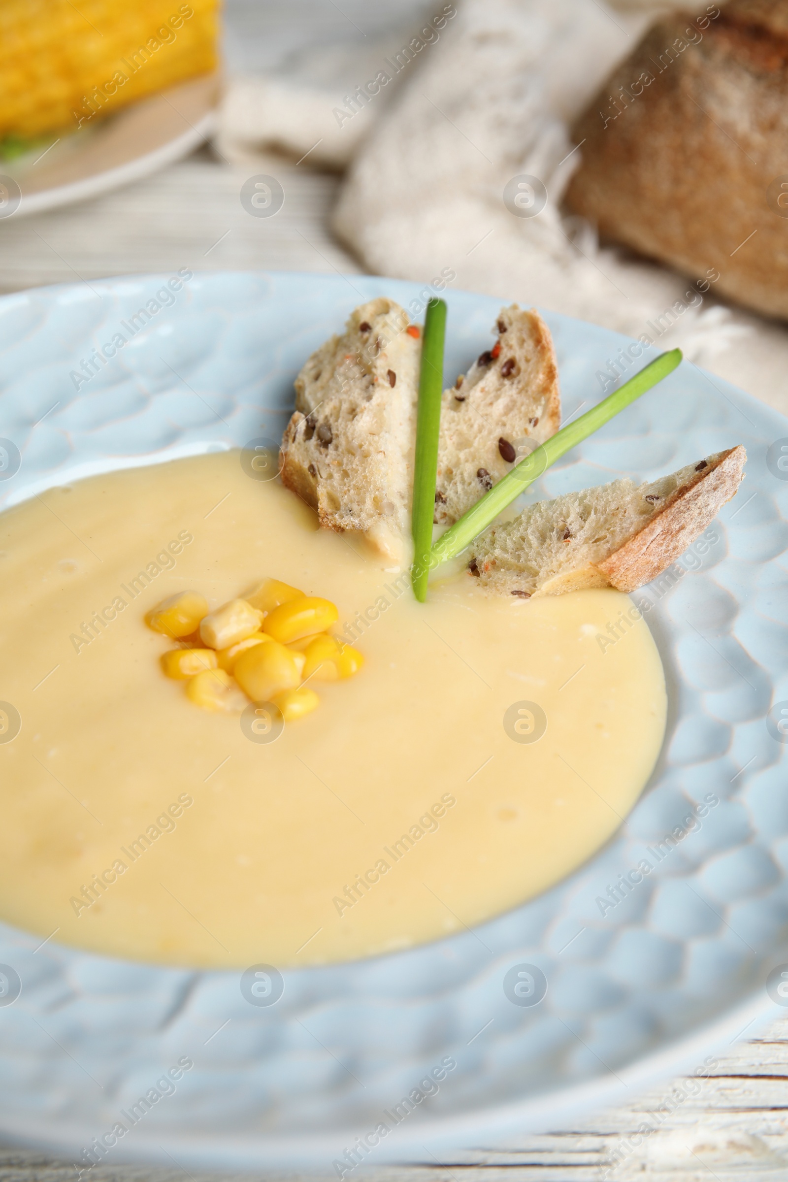 Photo of Delicious corn cream soup in bowl, closeup