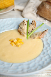 Delicious corn cream soup in bowl, closeup