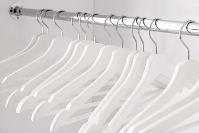 Photo of Clothes rail with hangers in wardrobe