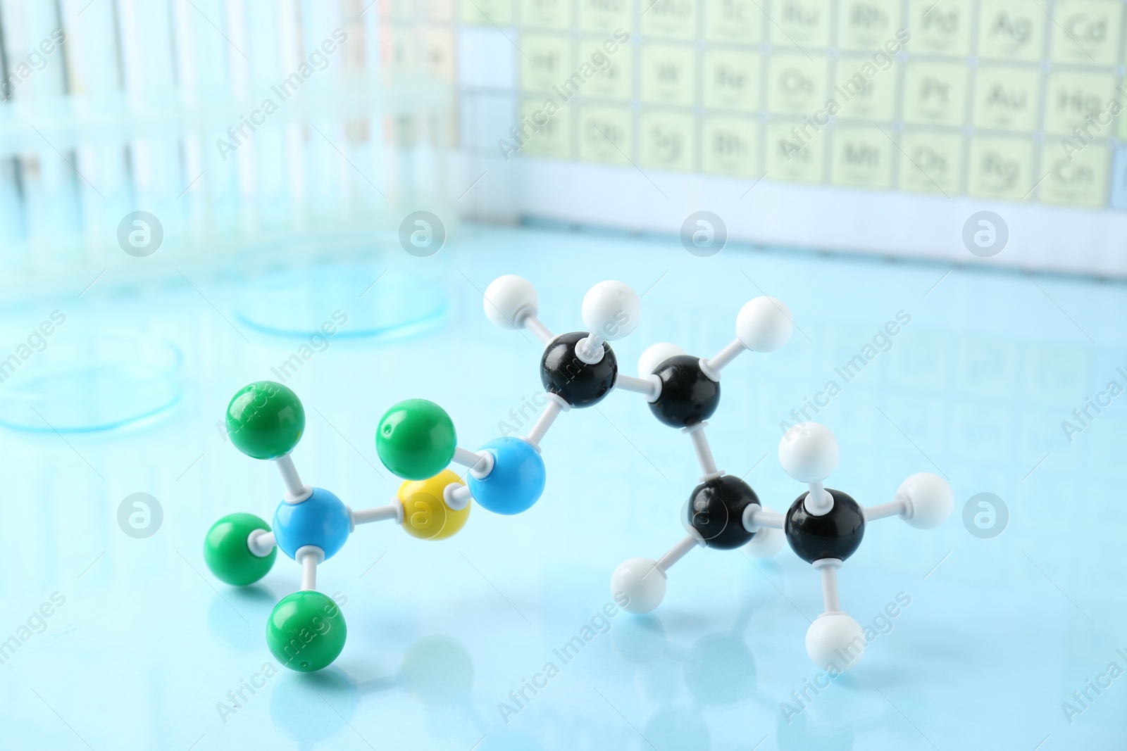 Photo of Molecular model on light blue glossy surface