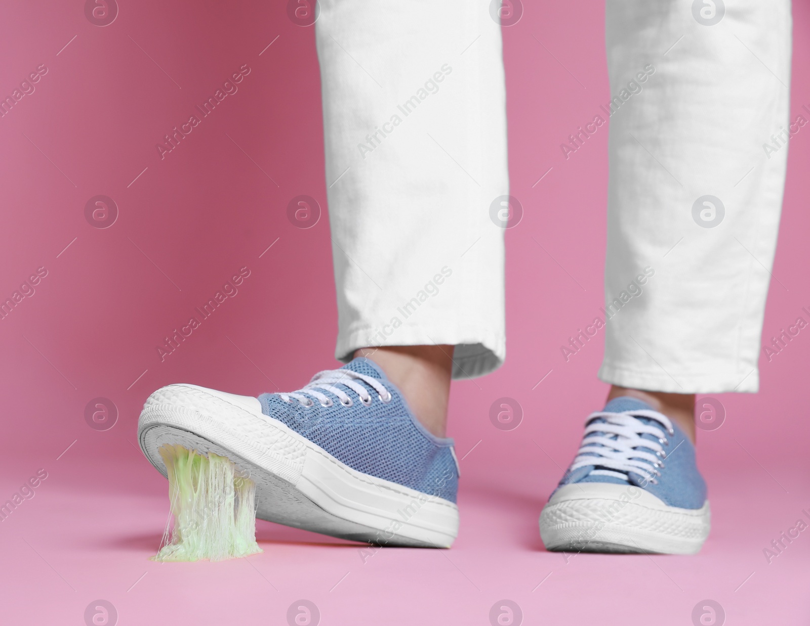 Photo of Person stepping into chewing gum on pink background, closeup. Space for text