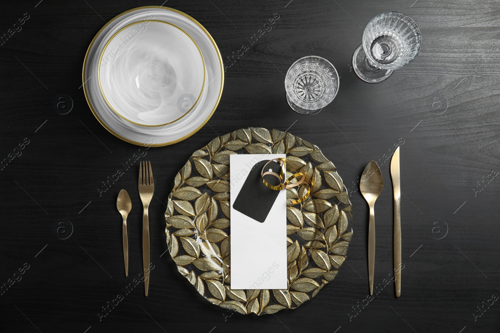 Photo of Elegant table setting on dark background, top view