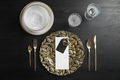 Elegant table setting on dark background, top view