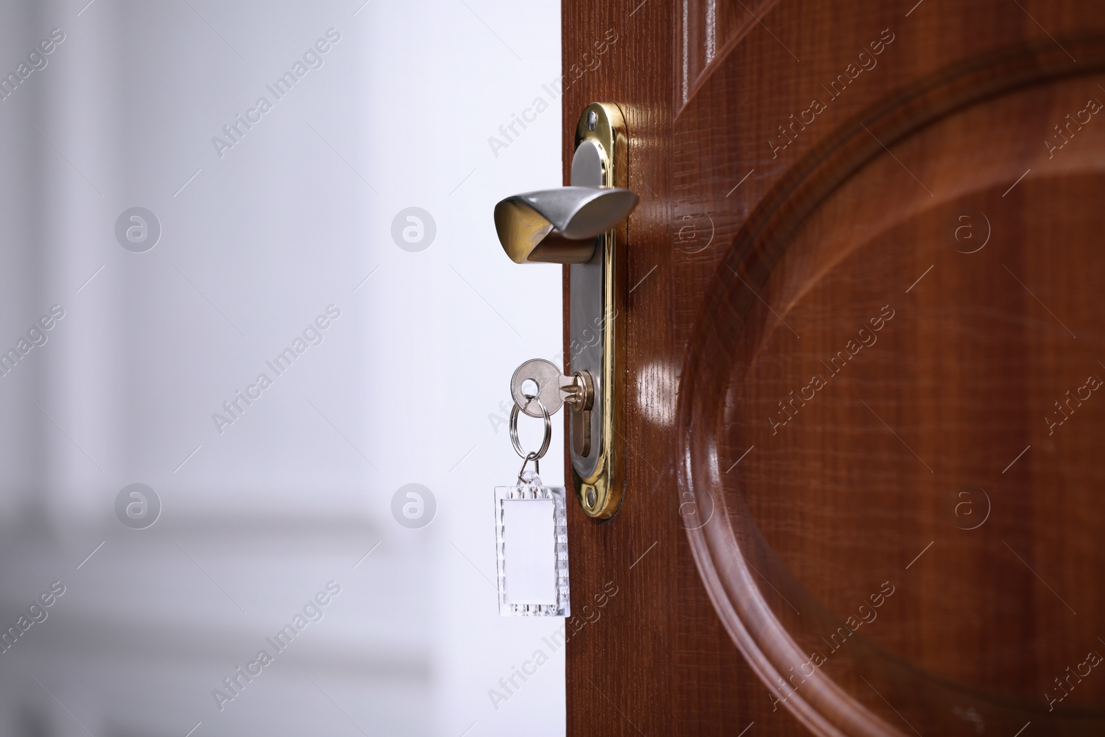 Photo of Closeup view of door with key in room, space for text