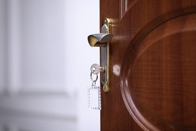Photo of Closeup view of door with key in room, space for text