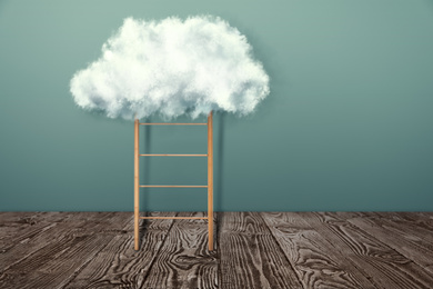 Wooden ladder with cloud near grey wall. Conceptual design 