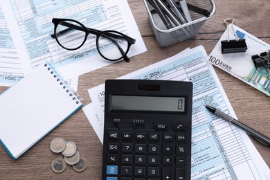 Tax accounting. Flat lay composition with calculator and documents on wooden table