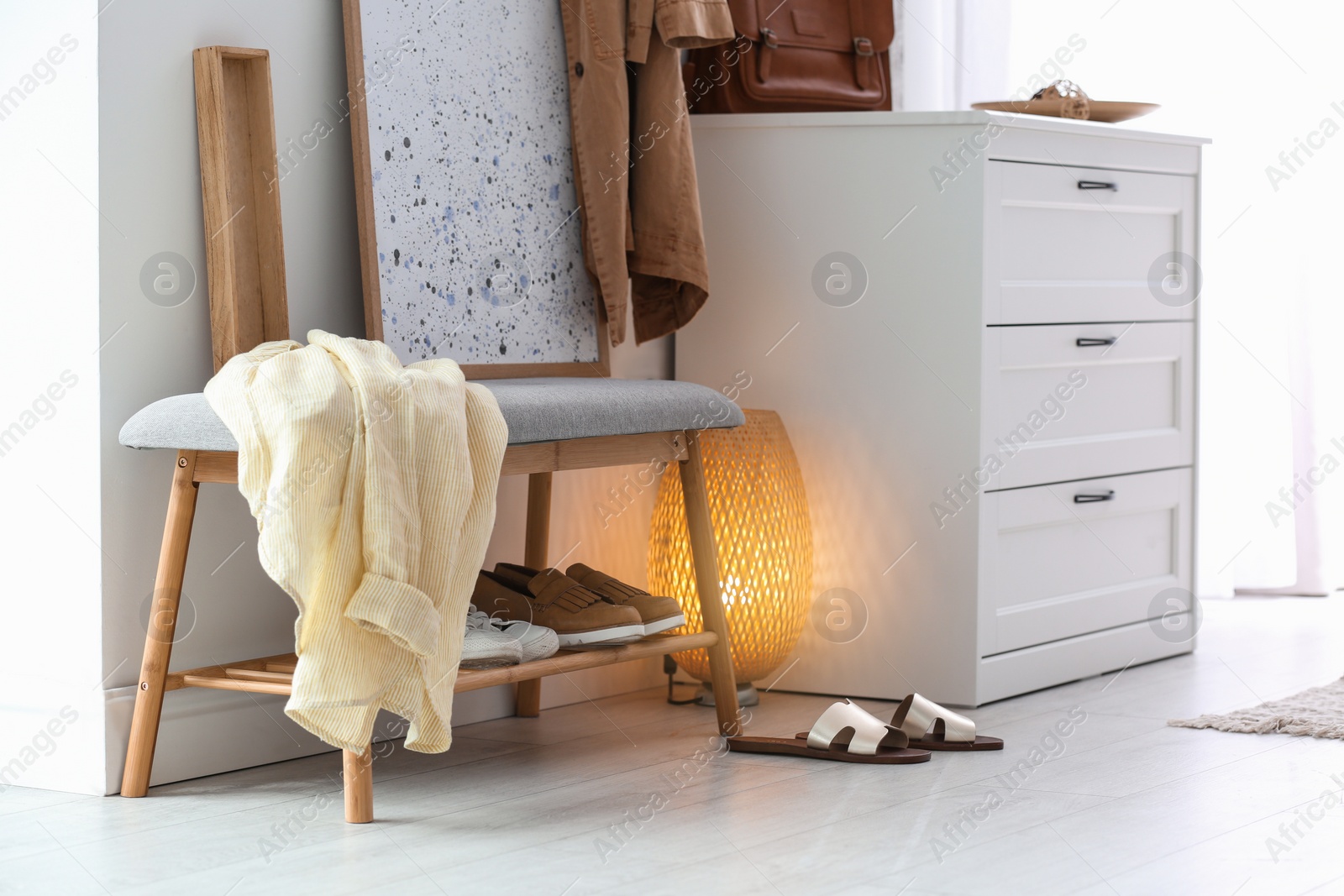 Photo of Modern hallway interior with shoe storage bench and chest of drawers