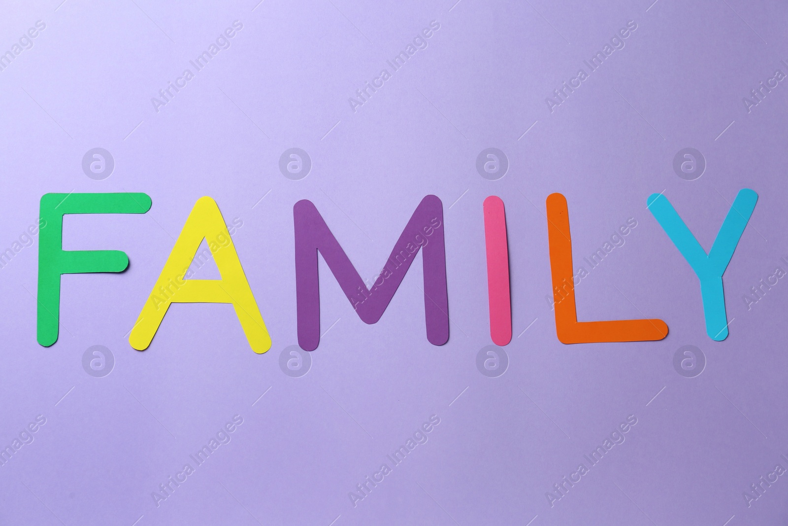 Photo of Word Family made of colorful paper letters on violet background, flat lay