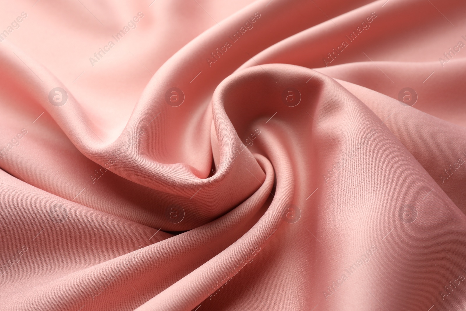 Photo of Crumpled pink silk fabric as background, closeup