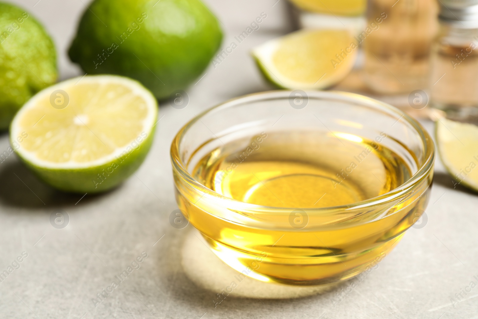 Photo of Lime essential oil in bowl on light table