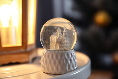 Photo of Snow globe with Christmas trees and deer on white table