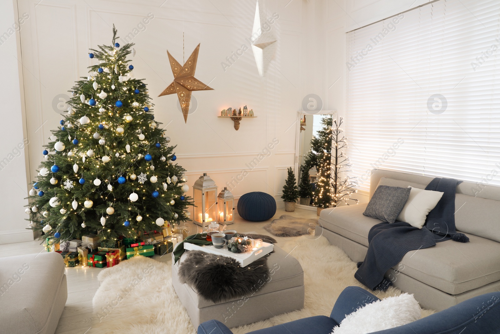 Photo of Cozy living room interior with beautiful Christmas tree and comfortable sofa