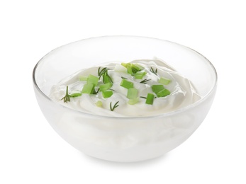 Photo of Bowl with sour cream and herbs on white background