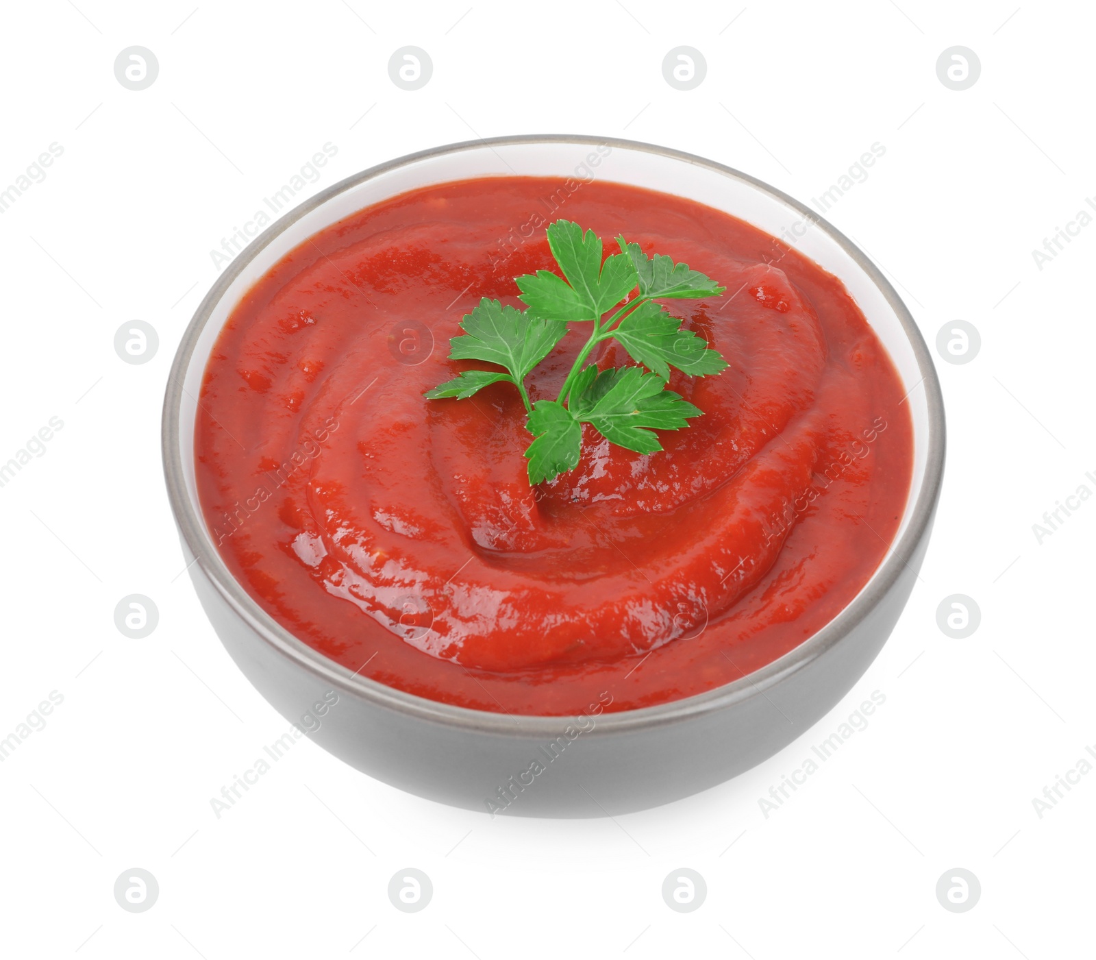 Photo of Organic ketchup and parsley in bowl isolated on white. Tomato sauce