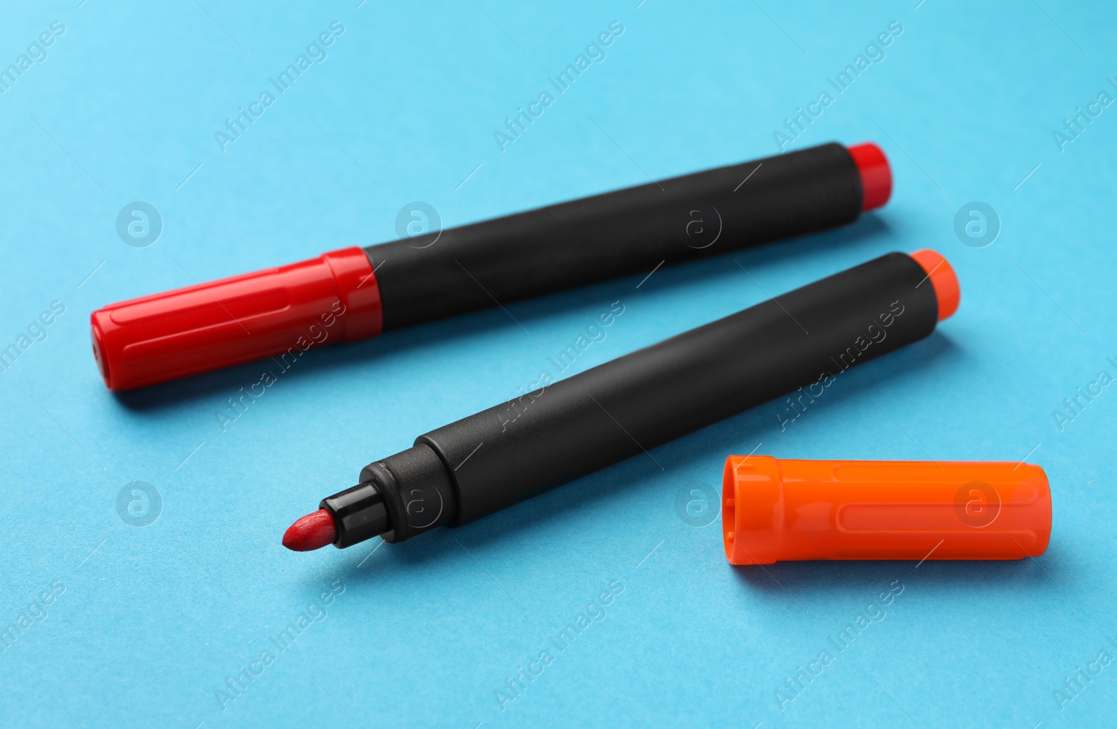 Photo of Bright color markers on light blue background
