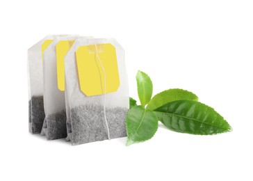 Image of Tea bags with leaves on white background