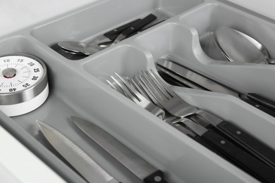 Photo of Box with different utensils, closeup. Order in kitchen