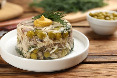 Delicious aspic with meat on wooden table, closeup