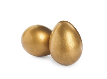 Two shiny golden eggs on white background