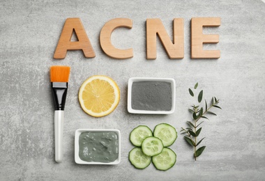 Photo of Word "Acne" and homemade effective problem skin remedies on grey background, flat lay