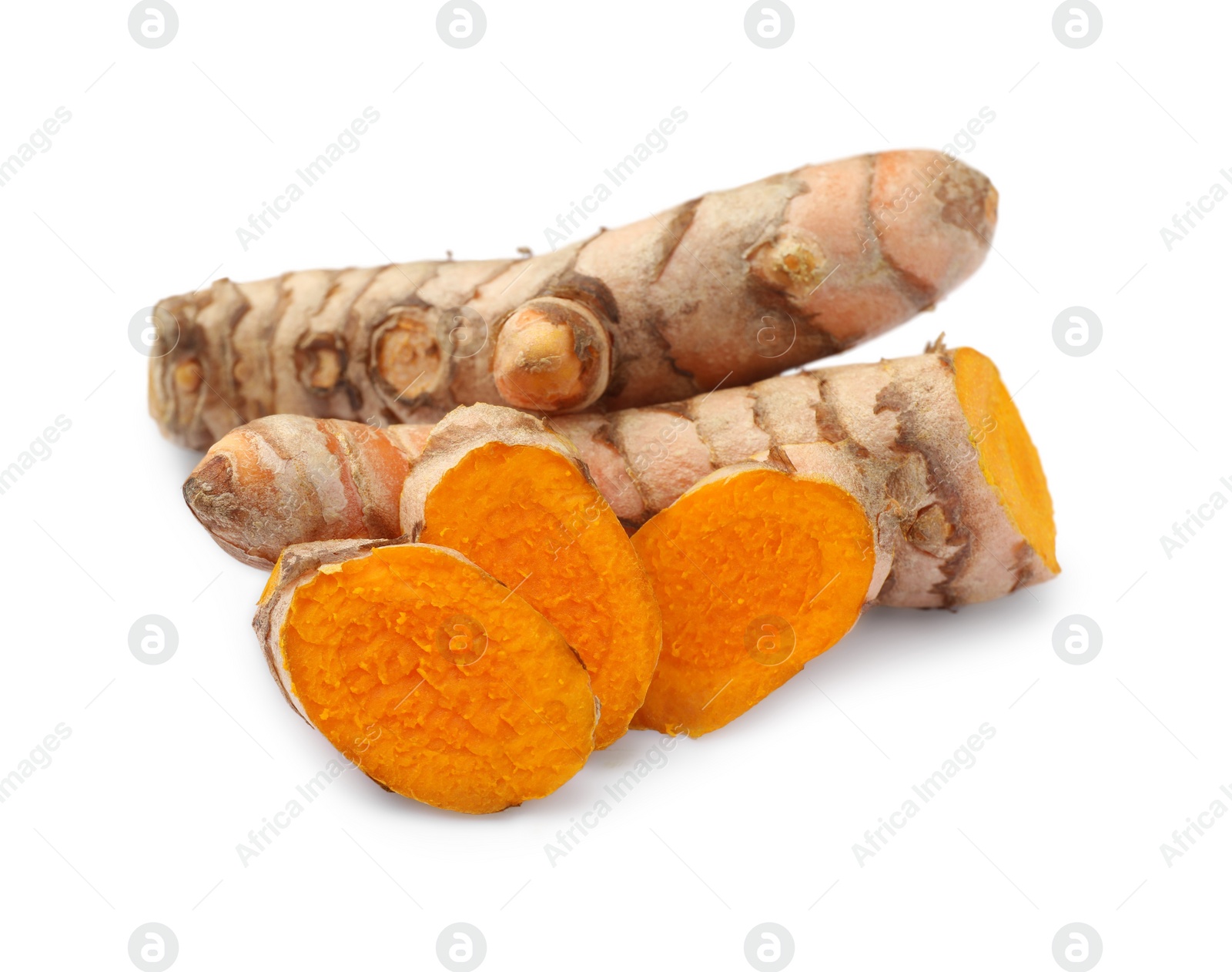 Photo of Whole and cut turmeric roots isolated on white