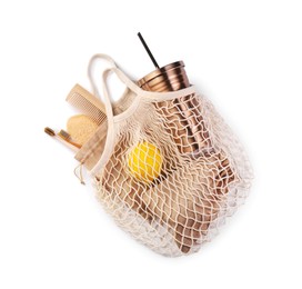 Photo of Mesh bag with different items isolated on white, top view. Conscious consumption