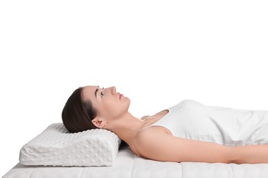 Woman lying on orthopedic pillow against white background