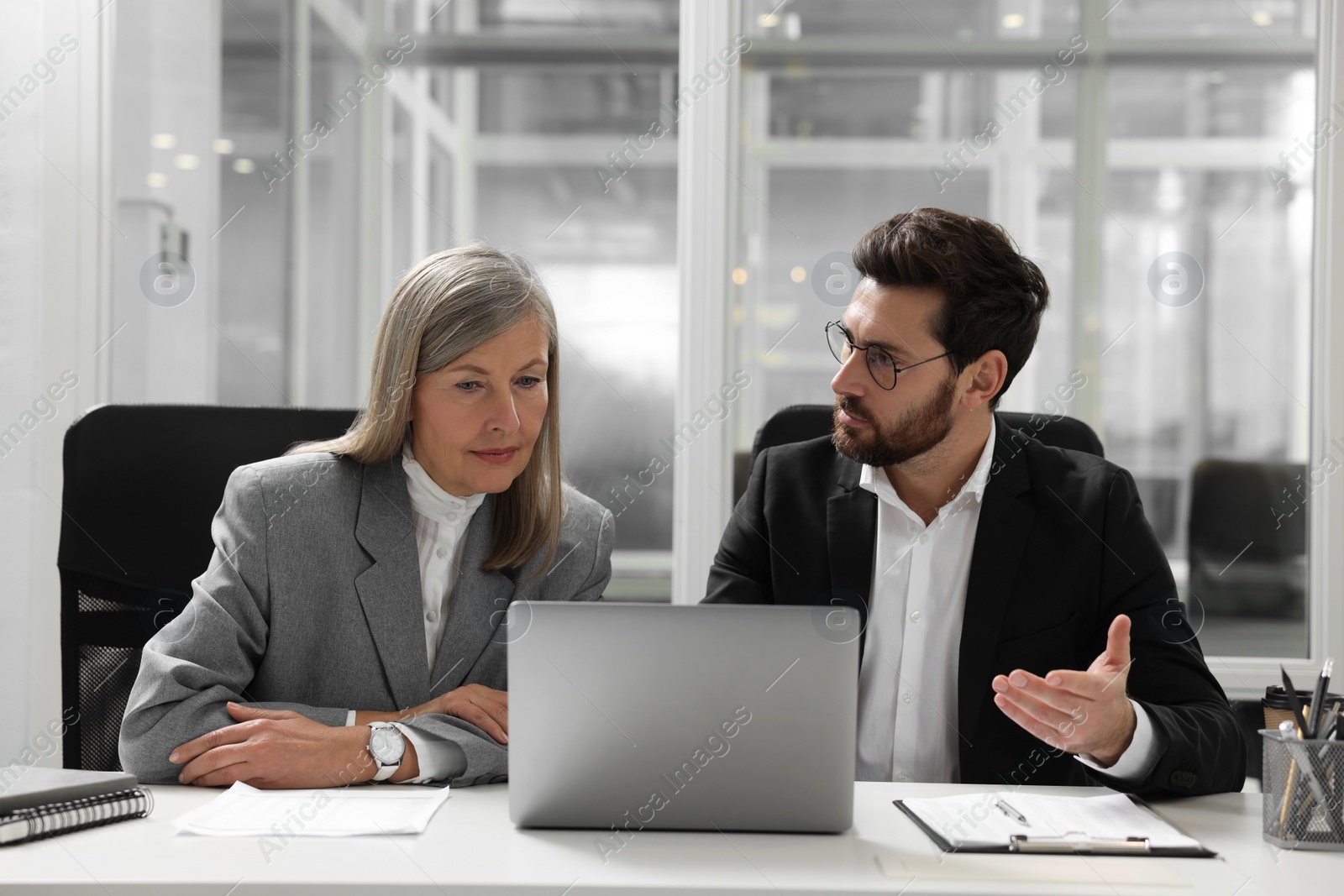 Photo of Lawyers working together at table in office