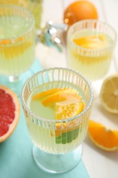 Photo of Delicious refreshing lemonade with orange slices on white table