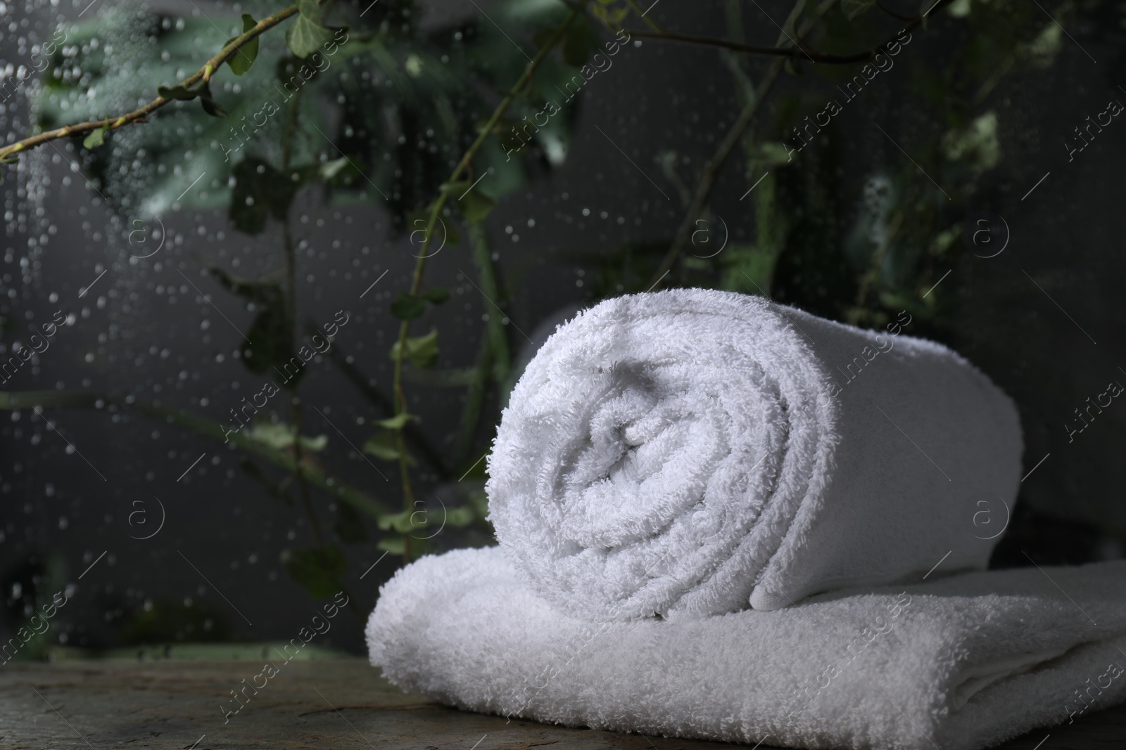 Photo of White terry towels on table in bathroom, space for text