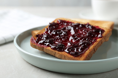 Photo of Delicious crispy toasts with jam on table, closeup