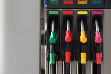 Petrol pump filling nozzles at gas station